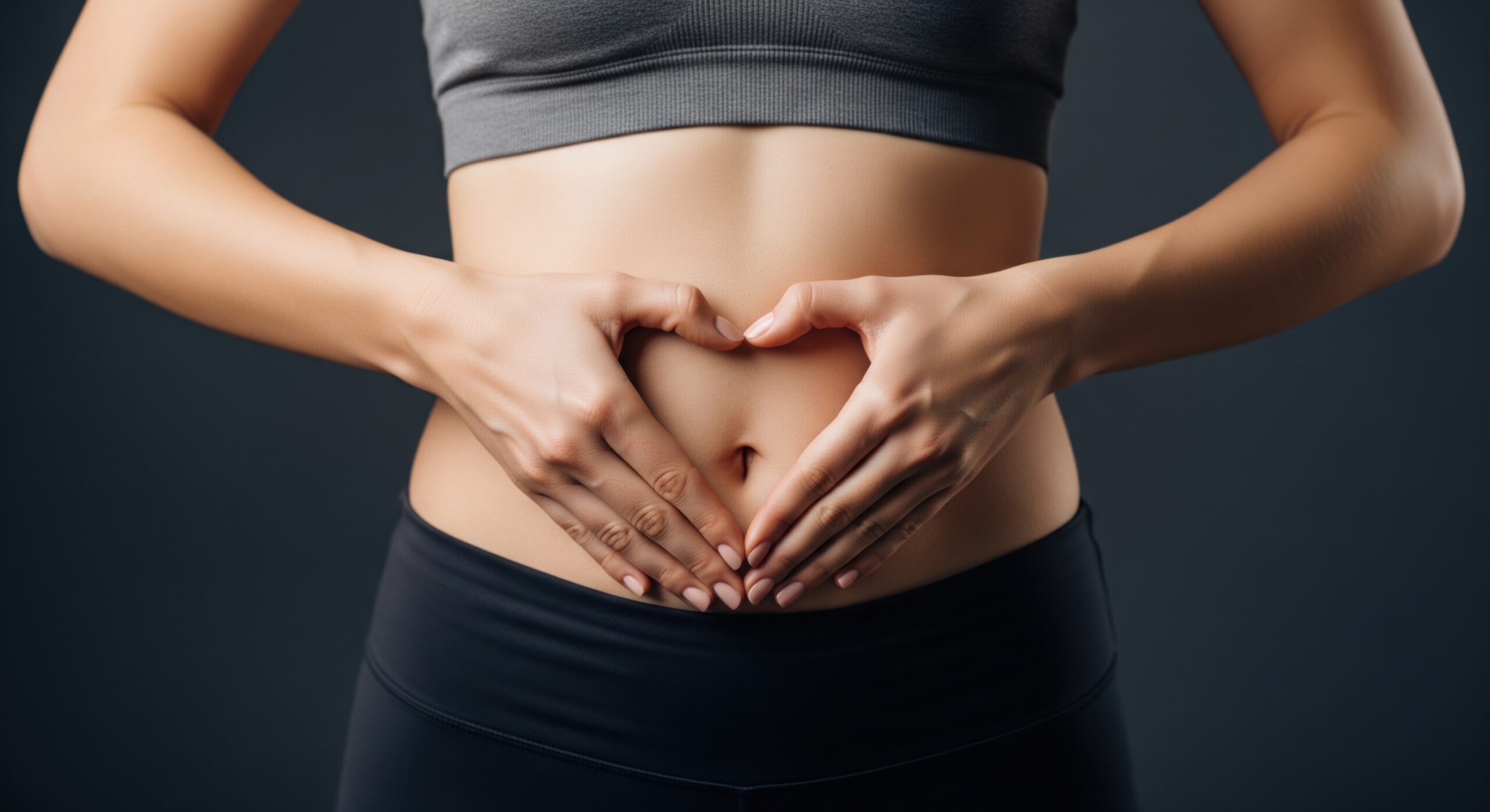Female abdomen with hands forming heart shape, representing digestive health, gut care, metabolic balance, hormone regulation, and preventive medicine concept in modern healthcare